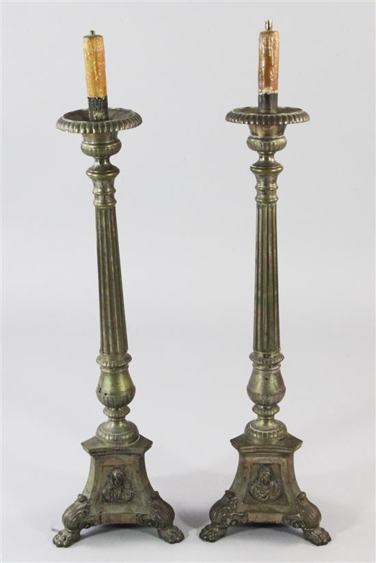 A pair of decorative brass altar sticks, 41in.